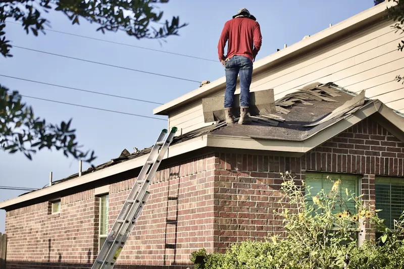 Professional roofer working on a residential roof in Oaklyn Manor